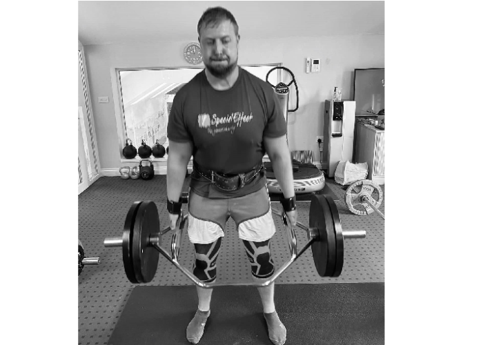 Adam Forder lifting weights for SpecialEffect